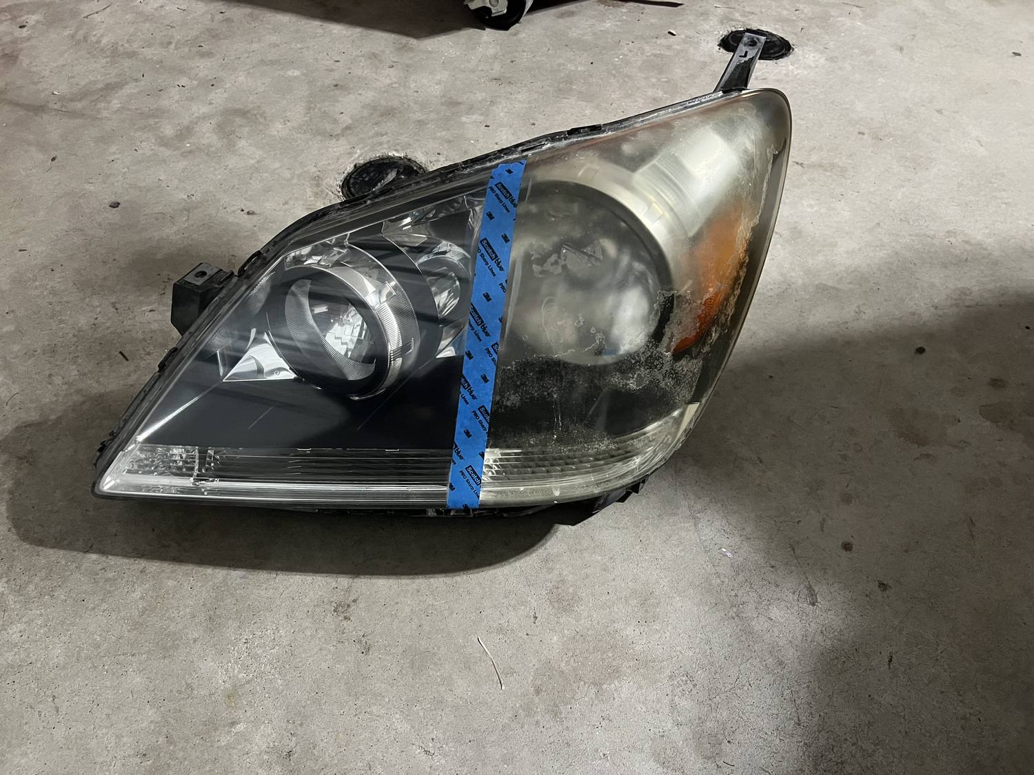 Headlight restoration before and after — oxidized yellowed lens on the right, fully restored clear lens on the left.